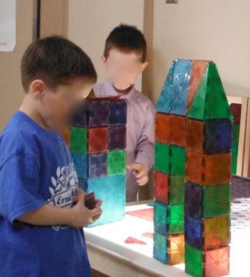 child building with magna tiles